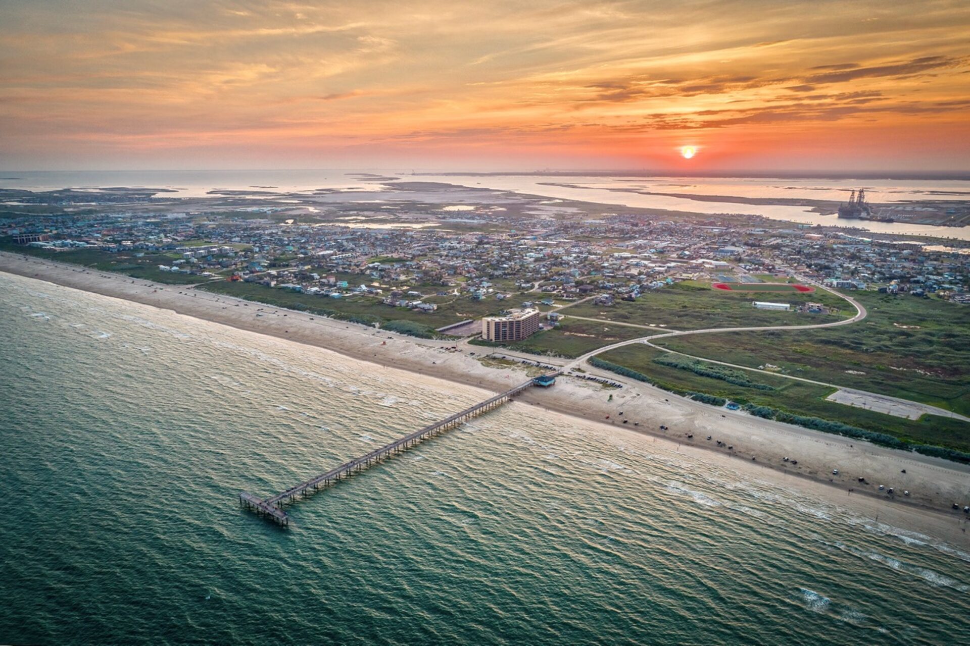 Sunset over Horace Caldwell Pier in Port Aransas, Texas — golden Gulf Coast sky and silhouetted pier